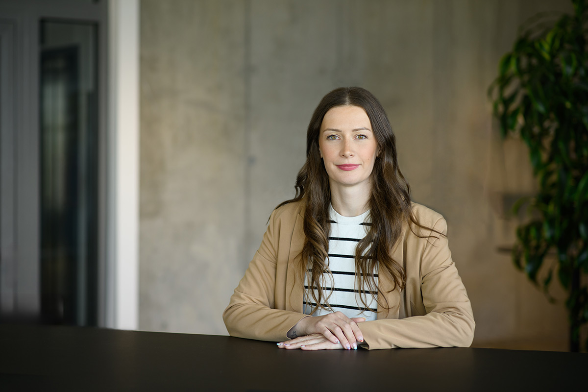 Porträt einer TeamQ-Mitarbeiterin am Konferenztisch – Beratung und Zusammenarbeit.